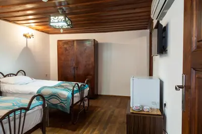 a room with two beds and a mirror in it at Lal Hotel Bursa in Bursa