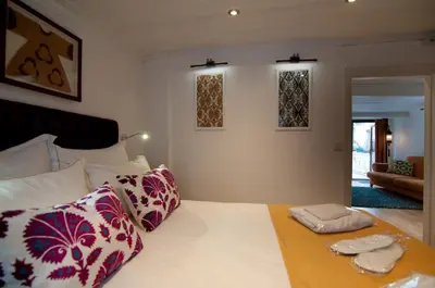 a bedroom with a large bed with colorful pillows at Blue Mosque Suites-Old City Sultanahmet in Istanbul