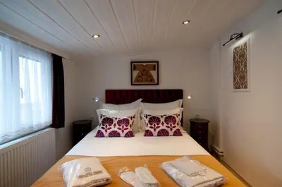 a bedroom with a bed with two towels on it at Blue Mosque Suites-Old City Sultanahmet in Istanbul