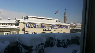 a view of a building with a flag and a mosque at Waha Hotel in Bursa