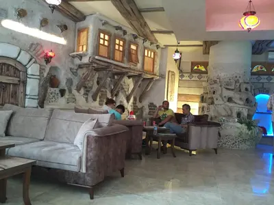 a group of people sitting in a living room at Waha Hotel in Bursa