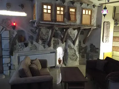 a living room with a couch and a fireplace at Waha Hotel in Bursa