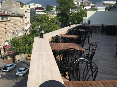 a row of tables and chairs on a roof at Waha Hotel in Bursa