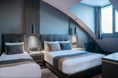 a bedroom with two beds and a staircase at Trendlife Hotels Uludağ ALL INCLUSIVE in Uludag