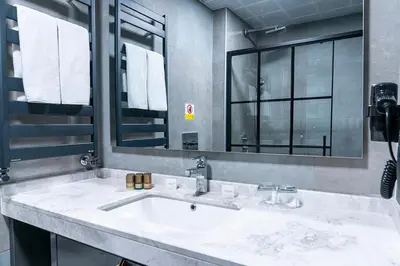 a bathroom with a sink and a large mirror at Trendlife Hotels Uludağ ALL INCLUSIVE in Uludag