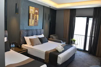 a hotel room with two beds and a window at Trendlife Hotels Uludağ ALL INCLUSIVE in Uludag