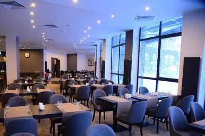 a dining room with tables and chairs and windows at Trendlife Hotels Uludağ ALL INCLUSIVE in Uludag