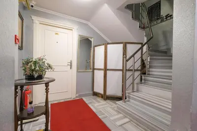a hallway with a staircase with a red carpet at Loren Hotel&Suites in Istanbul