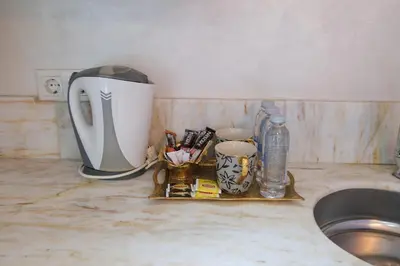 a tea kettle and other items on a tray next to a sink at Loren Hotel&Suites in Istanbul