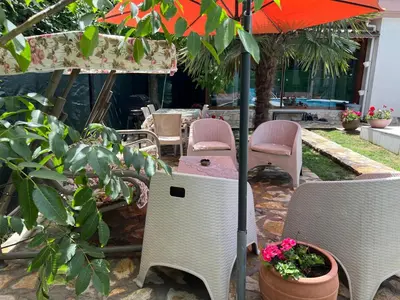 a patio with chairs and a table and an umbrella at Villa Onuk in Sapanca
