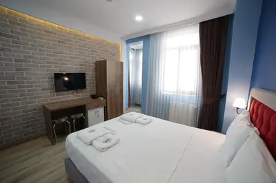 a hotel room with a bed with towels on it at Taksim Park in Istanbul