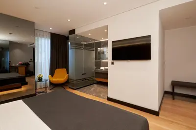 a hotel room with a bed and a flat screen tv at Metropolitan Hotels Bosphorus - Special Category in Istanbul