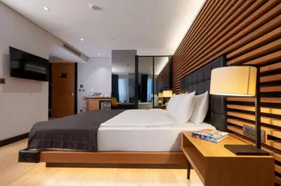 a bedroom with a large bed and a table with a lamp at Metropolitan Hotels Bosphorus - Special Category in Istanbul