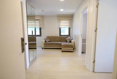 a living room with a couch and a glass door at Uçar Royal Hotel ve Konferans Salonu in Sile