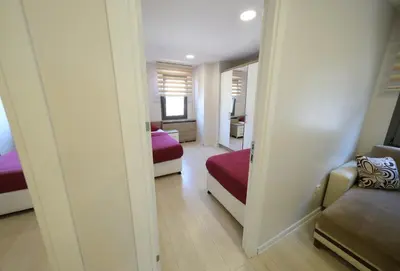 a room with two beds and a couch and a mirror at Uçar Royal Hotel ve Konferans Salonu in Sile