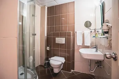 a bathroom with a toilet and a sink and a shower at Tiara Buyukada in Buyukada