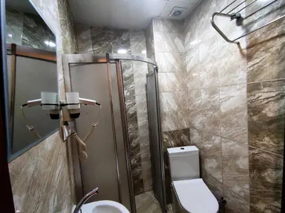 a bathroom with a shower and a toilet and a sink at Grafen House in Istanbul