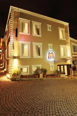 a large building on a cobblestone street at night at Apple Tree Hotel in Istanbul