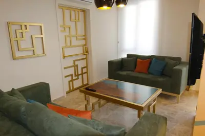 a living room with two couches and a coffee table at Zin D Home Otel Cekmeköy in Istanbul