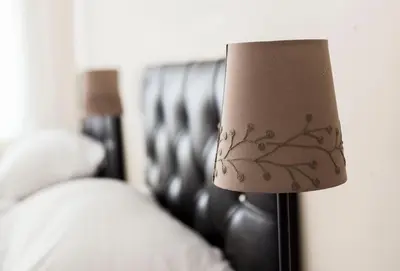 a bedroom with a bed with a lamp next to it at Villa Park Apart in Istanbul