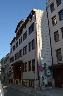 a tall white building with a street light next to it at Atlas Otel in Bursa