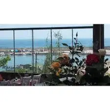 a view of the ocean from a balcony at Gizlibahce Hotel in Karaburun