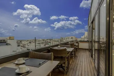 a balcony with tables and chairs and a view of a city at Hotel Venera Istanbul Old City in Istanbul
