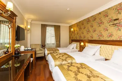 a hotel room with two beds and a television at Acra Hotel - Special Category in Istanbul