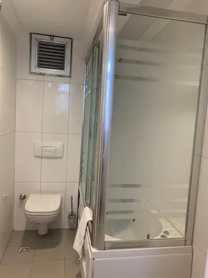 a bathroom with a shower and a toilet and a sink at Ada Hotel Istanbul in Istanbul