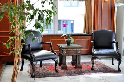 two chairs and a table with a vase on it at Hotel Centrum Istanbul in Istanbul