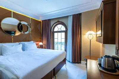 a bedroom with a large bed and a mirror on the wall at Wyndham Istanbul Old City in Istanbul