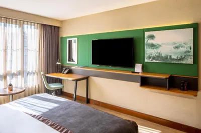 a hotel room with a bed and a flat screen tv at Holiday Inn Sisli by IHG in Istanbul