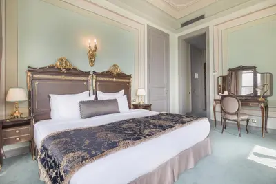 a bedroom with a large bed and a table and chairs at Bosphorus Palace Hotel in Istanbul