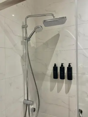 a shower with two bottles of soap in a bathroom at Misafir Suites 8 Istanbul in Istanbul