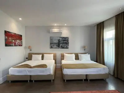 a room with two beds in a room at Misafir Suites 8 Istanbul in Istanbul