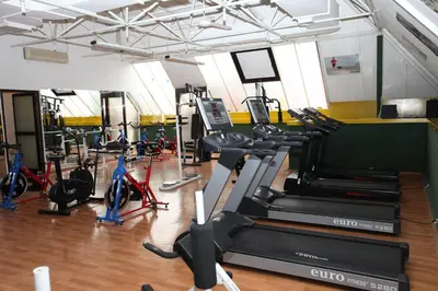 a gym with several treadmills and elliptical machines at Güneş Hotel Merter in Istanbul