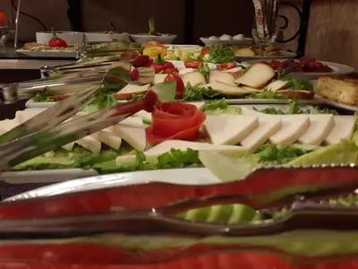 a buffet line with cheese and vegetables on plates at Triada Hotel Taksim - Special Category in Istanbul