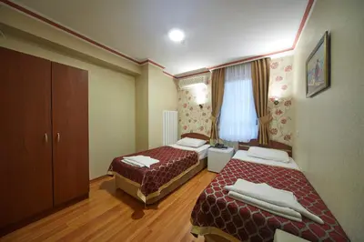 a hotel room with two beds and a window at Hotel Akcinar in Istanbul