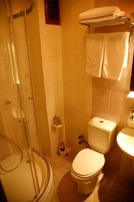 a bathroom with a shower and a toilet and a sink at Hotel Akcinar in Istanbul