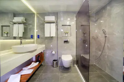 a bathroom with a sink and a shower and a toilet at Hotel Bulvar Palas in Istanbul