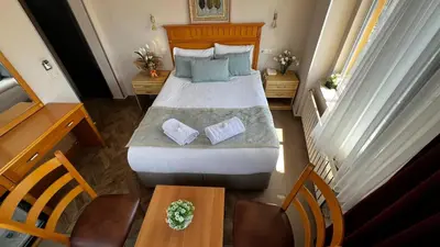 a bedroom with a large bed and a table at Park Star Hotel Taksim in Istanbul