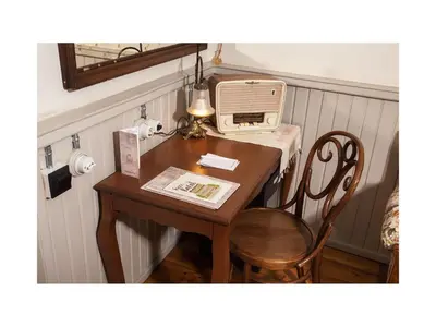 a table with a chair and a computer on it at Hotel Troya Balat in Istanbul