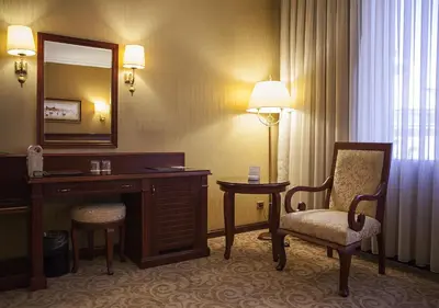 a hotel room with a desk and a chair and a mirror at Bilek Istanbul Hotel in Istanbul