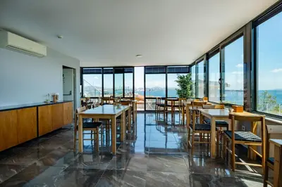 a restaurant with tables and chairs and large windows at Mangana Konak Hotel in Istanbul