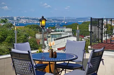 a table and chairs on a balcony with a view at Aldem Hotel in Istanbul