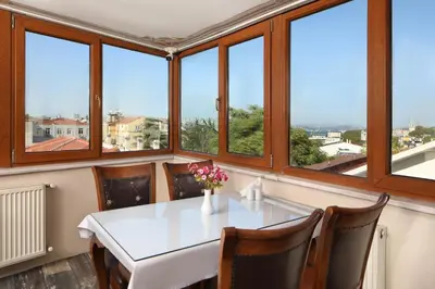 a room with a table and chairs and windows at Aldem Hotel in Istanbul