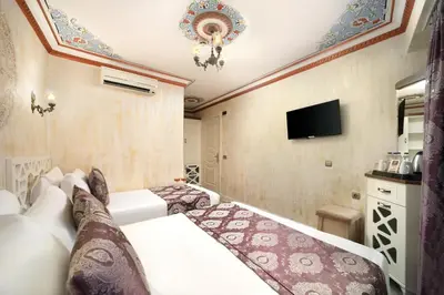 a bedroom with a bed and a flat screen tv at Aldem Hotel in Istanbul