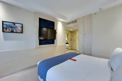 a bedroom with a bed and a tv on a wall at Ramada by Wyndham Istanbul Old City in Istanbul