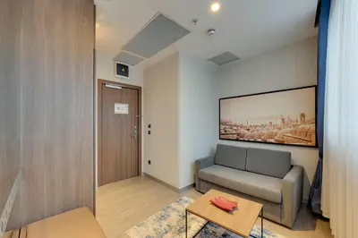 a living room with a couch and a table at Ramada by Wyndham Istanbul Old City in Istanbul
