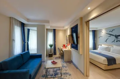 a hotel room with a bed and a couch at Ramada by Wyndham Istanbul Old City in Istanbul